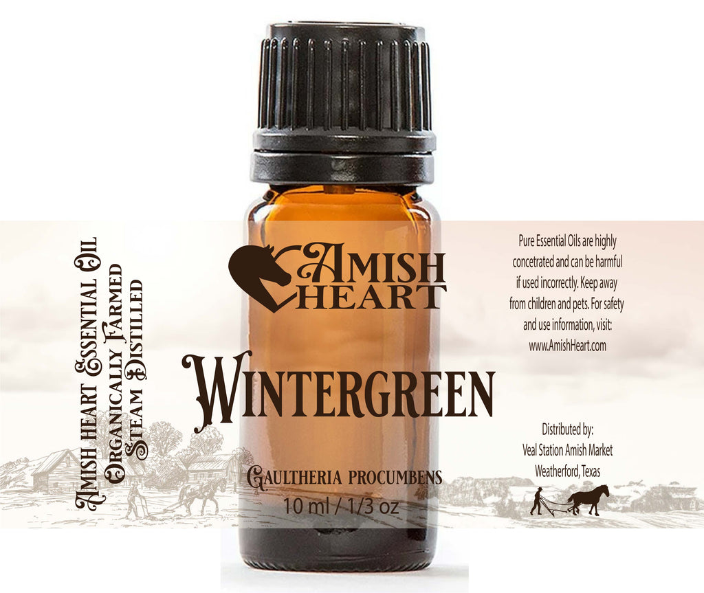 A 10ml bottle of Amish Heart Wintergreen Essential Oil with a child-proof cap, sourced from wildcrafted leaves in Nepal.
